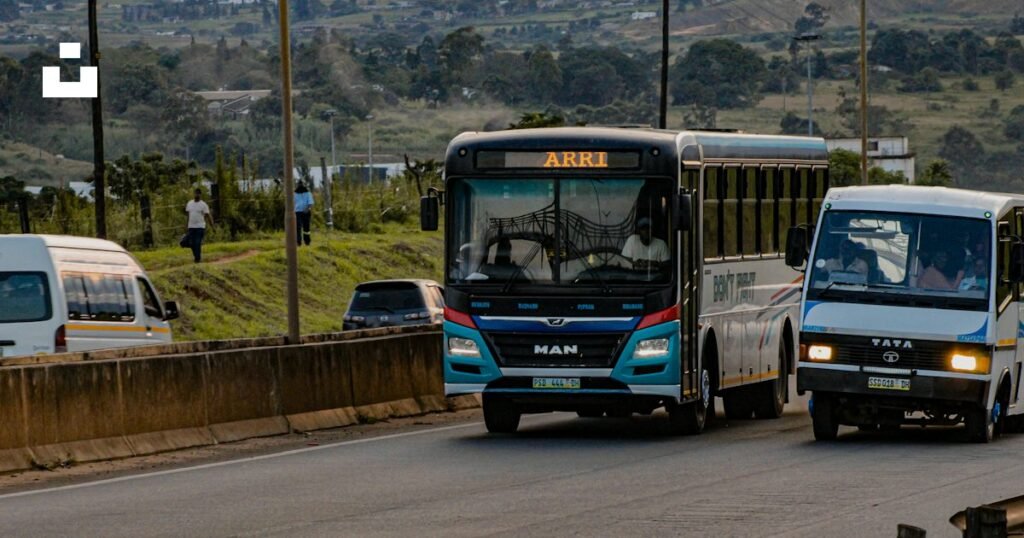 Two buses traveling on a highway for an Atlanta to Denver guide