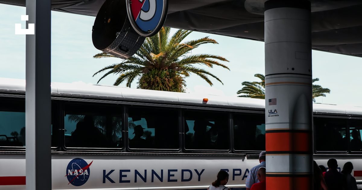 White and red bus traveling on a Florida road