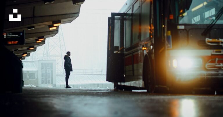 Passenger waiting beside a bus at a bus station