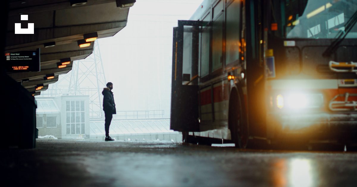 Passenger waiting beside a bus at a bus station